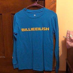 Left sleeve says don’t smile at me in yellow letters, figure on right sleeve